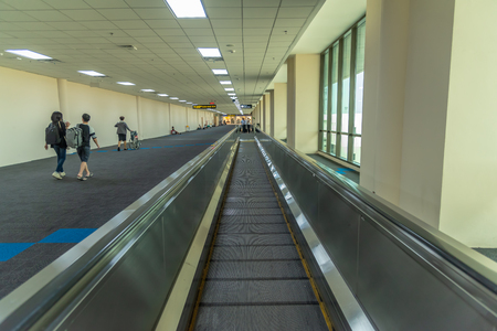 Bangkok Thailand , April 2, 2018 : Unidentified passenger on a moving walkway escalator in the Don Mueang international airport in Bangkok,Thailand.のeditorial素材