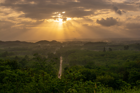 Beautiful sunrise over mountain village with clouds and country road in Thailand.の写真素材
