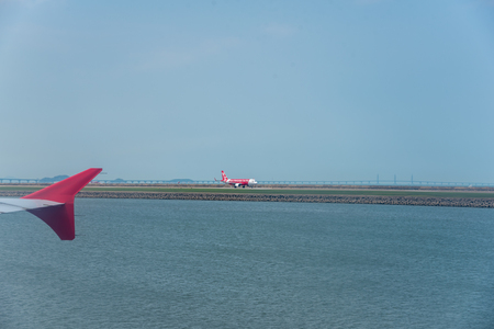 Macua- May 2,2018 : Air asia goes to the position for takeoff at an airport runway at marcau airport.のeditorial素材