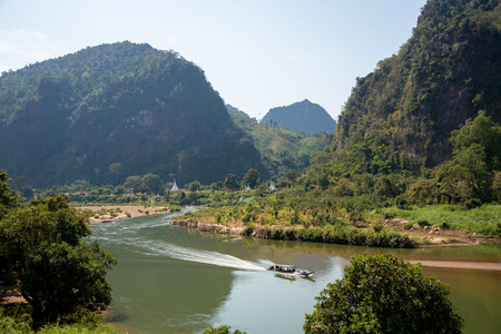 Mountain landscape view with river boat and white pagodas located in northern of Thailandの写真素材