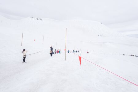 Tateyama, Japan - April 21, 2019 : Unidentified tourists visiting snow corridor on Tateyama Kurobe Alpine Route, Japanese Alp in Tateyama, Japan.のeditorial素材