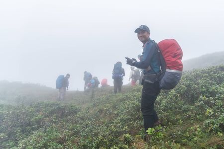 Phatthalung, Thailand-December  31, 2019: The trekkers trekking on foggy the mountains in jungle of...