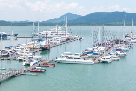 Phuket, Thailand - April 2019 : Row of yachts at the harbor and Many luxury boats at Phuket Yachts Haven Marina in Phuket, Thailand.のeditorial素材