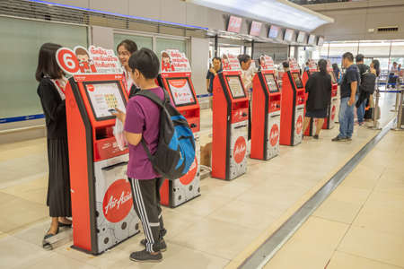 Bangkok, Thailand - April 04, 2019 : Interior with passenger check in at Airasia check in machine in Don Mueang International Airport, Bangkok.のeditorial素材