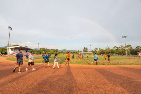 Surat Thani, Thailand - April 05, 2019 : People running on a red gravel track before sunset in Surat Thani, Thailand.のeditorial素材