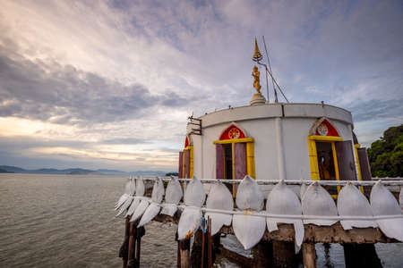 long bridge to pagoda of temple "Wat Koh Phayam" in the Andaman sea and beautiful sunset/sun rise sky, Payam island, Ranong, Thailandの写真素材