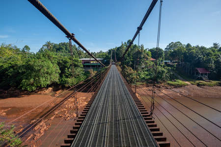 The suspension bridge over river, Surat Thani, Thailandの写真素材