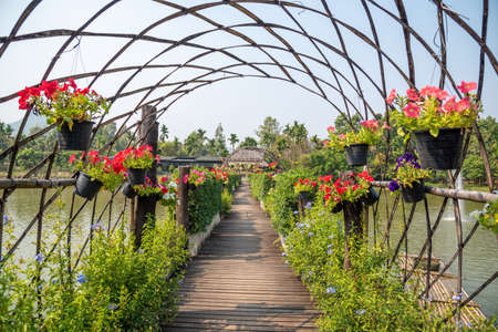 The wooden bridge park full of flowers in Thailandの写真素材