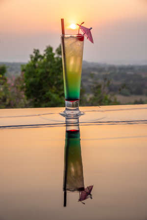 Cocktail near the swimming pool at sunset in Thailandの写真素材