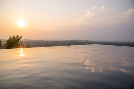 Sunset over the swimming pool with mountain view in Thailandの写真素材