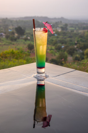 Cocktail near the swimming pool at sunset in Thailandの写真素材