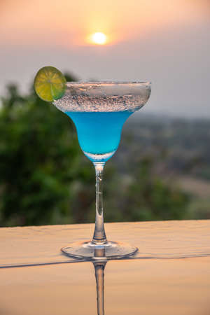 Cocktail near the swimming pool at sunset in Thailandの写真素材