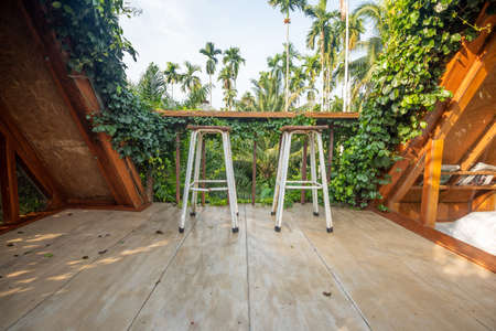 Beautiful rooftop bedroom with table and chair outside terrace with trees natureの写真素材