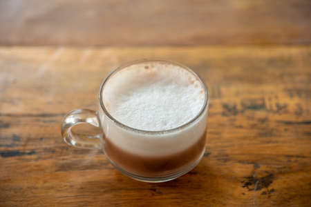 Homemade milk hot tea in glass on the tableの写真素材