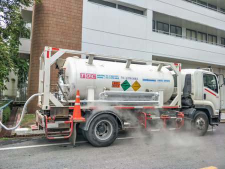 Pathumthani, Thailand - August 27 2021 : Liquid oxygen being loaded from a semi truck into storage tanks at a medical facility in Pathumthani hospital ,Thailand.のeditorial素材