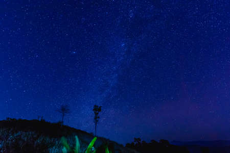 The sky dark blue with many stars and mountain range in Thailandの写真素材