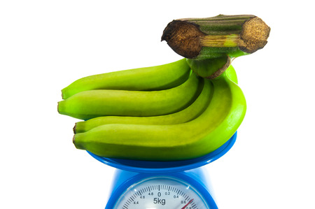 raw bananas on the weighing machineの写真素材