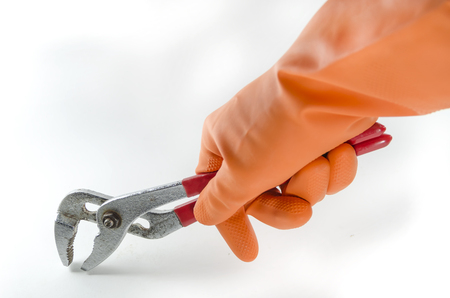wrench in a orange gloveの写真素材