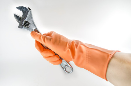 wrench in a orange gloveの写真素材