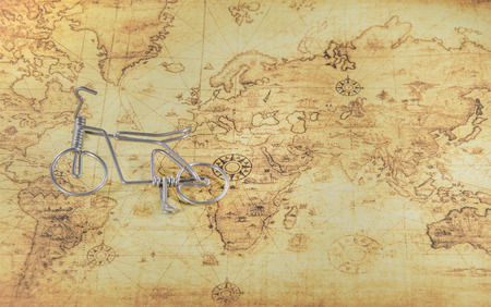 mini bicycle on a old world mapの写真素材