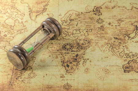 Hourglass on a old world mapの写真素材