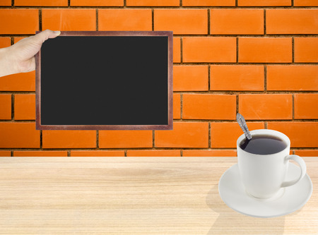 Chalkboard Coffee cup with brick backgroundの写真素材