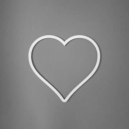 Beautiful heart white frame on gray background. Top view. Creative concept, flat lay.の写真素材