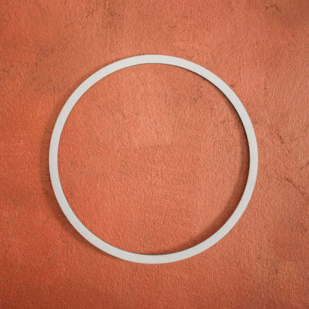 Circle white frame on red bronze wall background. Side view. Creative concept, copy space.の写真素材