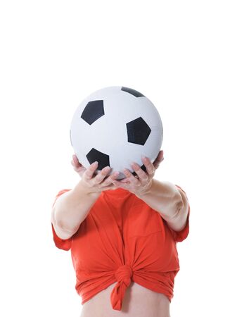 woman holding soccer ball in front of her faceの写真素材