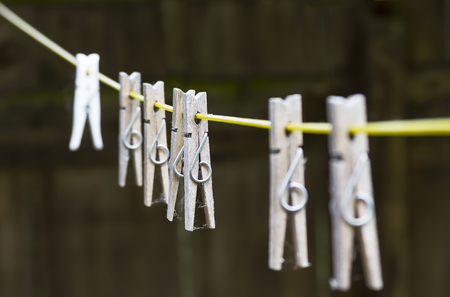 set of wooden pegs on washing lineの写真素材