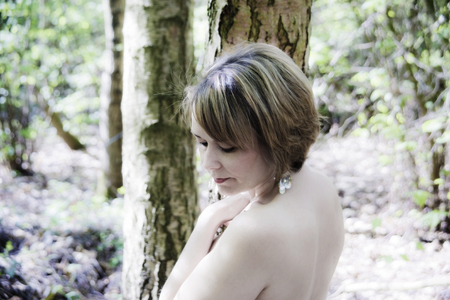 high key portrait of woman in woodland settingの写真素材