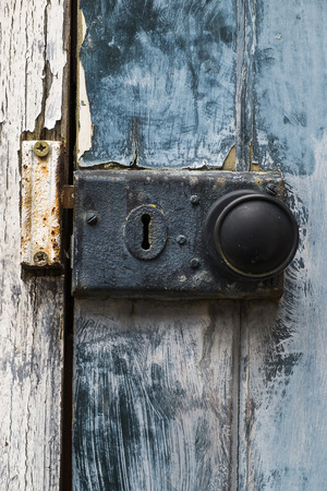 old rusty doorknob and lock on exterior doorの写真素材