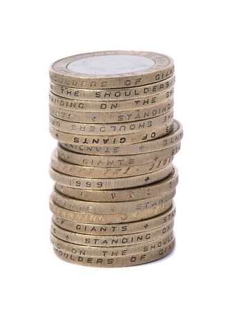 stacked uk two pound coins on whiteの写真素材