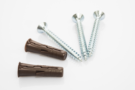 three screw and two raw plugs on white backgroundの写真素材