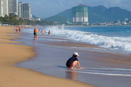 NHA TRANG, VIETNAM - DECEMBER 30, 2015: People relax on the beach of resort Nha Trang, sunny dayのeditorial素材