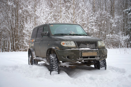 LENINGRAD REGION, RUSSIA - JANUARY 23, 2016: UAZ Patriot close-up on the edge of a winter forest cloudy dayのeditorial素材