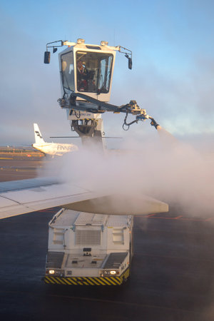 HELSINKI, FINLAND - NOVEMBER 01, 2014: Deicing treatment of an airplane wing at Helsinki Airportのeditorial素材
