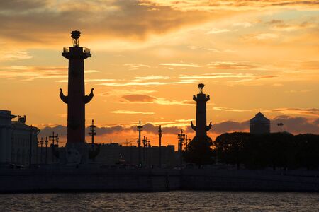 The silhouettes of the Rostral columns in the background of the sunset sky. Saint Petersburg, white nightの写真素材