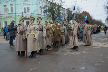 GATCHINA, RUSSIA - NOVEMBER 07, 2015: The participants of the international military-historical festival "Civil war in Russia. North-West, 1919" in formation on city streetのeditorial素材