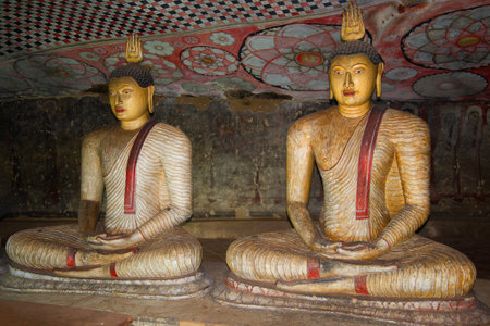 DAMBULLA, SRI LANKA-JUL 24, 2015: Two ancient sculptures of the seated Buddha in cave Buddhist temple (approximately I century BC)のeditorial素材