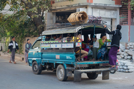 MANDALAY, MYANMAR - DECEMBER 20, 2016: Fxed-route passenger truck in the morning the streetのeditorial素材