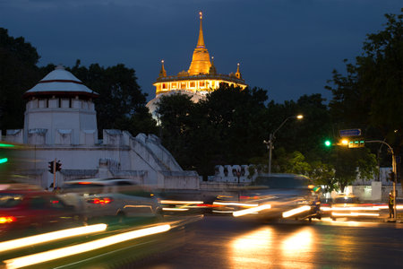 Chedi of the ancient buddhist temple Wat Saket over evening Bangkokのeditorial素材