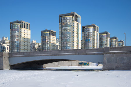 SAINT PETERSBURG, RUSSIA - FEBRUARY 27, 2017: 4th Smolensky bridge and body of a modern residential complex "Sea cascade" sunny day in February. Winter Saint-Petersburgのeditorial素材