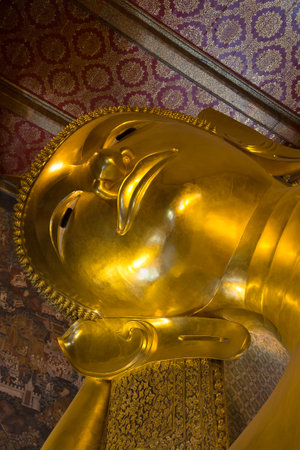 Head of the reclining Buddha close up in Buddhist temple Wat Pho. Bangkok, Thailandのeditorial素材