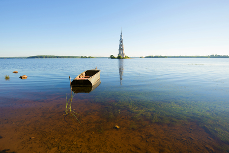 Morning panorama of the Uglich reservoir with the flooded bell tower and the old boat. Kalyazin, Russiaの写真素材