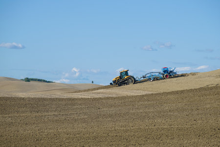 TUSCANY, ITALY-SEPTEMBER 21, 2017: Tracked tractor Challenger MT765D with pneumatic seed drill...