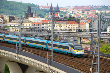 PRAGUE, CZECH REPUBLIC - APRIL 23, 2018: Modern high-speed train passes through the overpass on the...