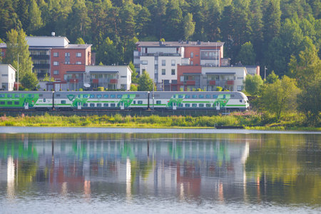 HAMENENLINA, FINLAND - JULY 24, 2018: Modern two-story passenger train on the shore of  Vanajavesi lakeのeditorial素材