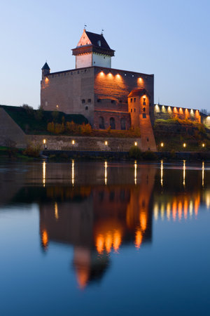 The medieval castle of Herman over the Narva river in the October twilight. Estoniaのeditorial素材