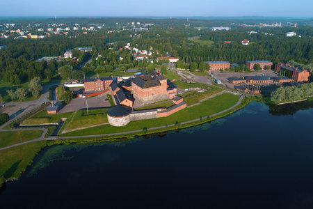 The ancient  Hameenlinna fortress  on the shore of Vanajavesi lake on a July morning (aerial photography). Finlandのeditorial素材